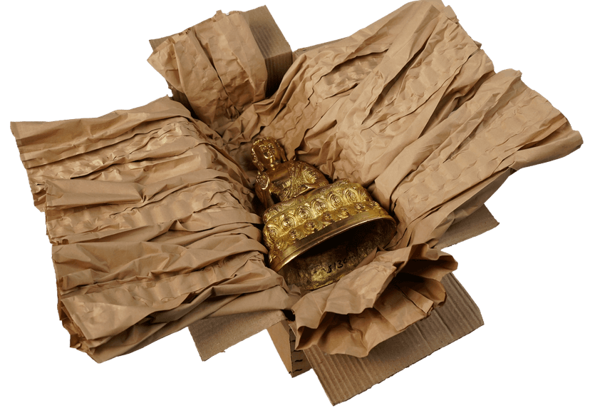Buddha idol wrapped in paper packaging